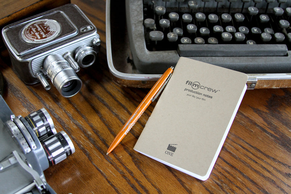 Our product; a small light grey pocket notebook with a label: Film Crew Professional Notes. 
