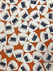 A bunch of white guitar picks with the word 'SURF' in navy blue and the image of a surfboard in sideview.